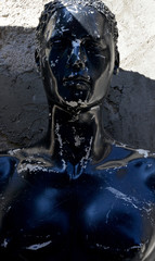 old mannequin in front of wall