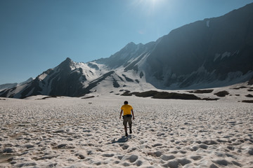 Fototapeta na wymiar hiker walking on a glacier in the italian alps