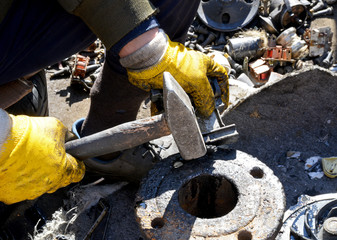 worker cutting metal with grinder