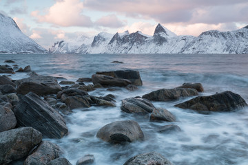 Panorama of snowy fjords and mountain range, Senja, Norway Amazing Norway nature seascape popular tourist attraction. Best famous travel locations. beautiful sunset within the amazing winter landscape