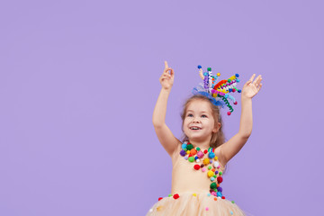 Childrens birthday party, masquerade. Little happy toddler child girl in a puffy tutu fancy dress,...