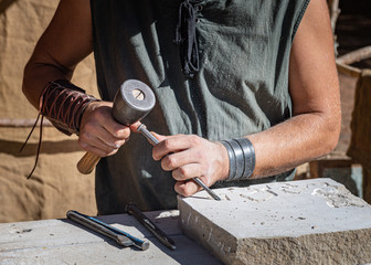 stone craftsman working in his stonekeeping workshop..