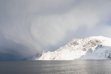 Panorama of snowy fjords and mountain range, Senja, Norway Amazing Norway nature seascape popular tourist attraction. Best famous travel locations. beautiful sunset within the amazing winter landscape