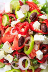 Greek salad with fresh vegetables and feta cheese background texture.