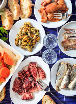 Cold ouzo, raki alcohol with seafood meze