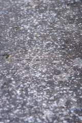 The sidewalk surface is full of bird droppings.
