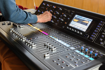 Sound engineer working, professional digital audio mixing console