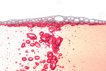 Red bubbles on white.Close up water bubbles underwater on white background.