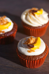 Delicious Easter cupcakes on table. Tasty chocolate cupcakes. Holiday Easter card. Cupcakes with cream and candy.