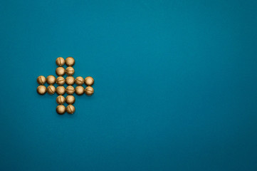 pills in cross shape on blue background - 328931608