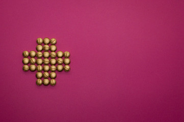 pills in cross shape on pink background - 328931625