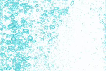 Close up water bubbles underwater on white background.Bright green bubbles on white.