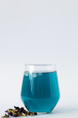 butterfly pea tea. Healthy lifestyle. glass of cold blue tea with dry flowers on a white background. blue herbal tea. Fresh Cold drinks. copy space