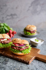 Vegetarian beetroot burger with Lollo Bionda lettuce, tartar sauce, red onion, zucchini and radish slices