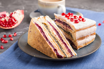 Homemade layered cake with pomegranate jam and a cup of coffee on a black concrete background. side view, selective focus.