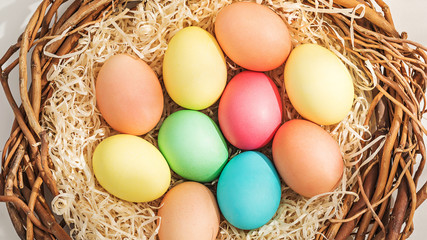 Rural Easter composition with colorful eggs in the nest