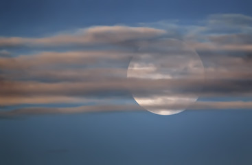 Full Moon In The Sky Behind The Clouds - 328933833
