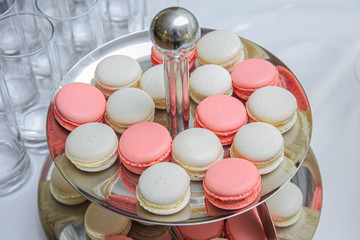 Colored round cakes on a stand. Sharpness in the middle