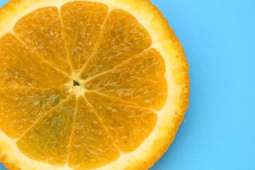 Orange slice macro.Juicy bright orange texture orange on a bright blue background close-up.Fruit...