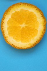 Orange slice macro.Juicy  orange texture orange on a bright blue background close-up.Fruit...