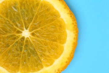 Orange slice macro.Juicy bright orange texture  on a bright blue background close-up.Fruit...