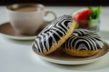 Doughnut with chocolate flavour filling, topped with white and black icing