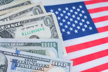 Banknotes of different denominations. Cash on the US flag. Dollars next to the flag. Trading...