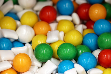 Fototapeta na wymiar Chewing gumballs, colorful jelly candy. Green, yellow, blue and white gummy marmalade for background