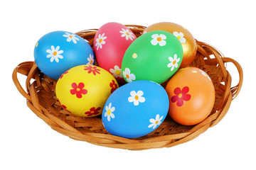 Fototapeta na wymiar Colorful painted Easter eggs in the basket on the white background