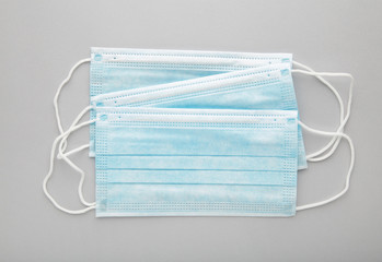 Medical masks on a grey background with copy space. Coronavirus