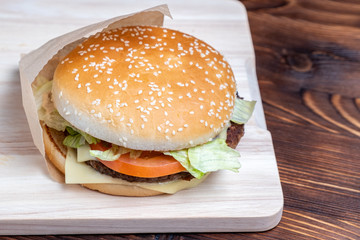 Burger in paper and on a light board