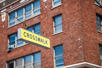 crosswalk sign and shoes on the line