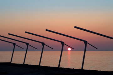 Silhouette of the metal constructions on the beach