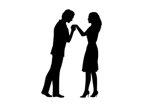 Silhouette of man kissing woman hand