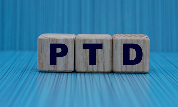 the concept of the word PTD on cubes on a blue background in a stripe