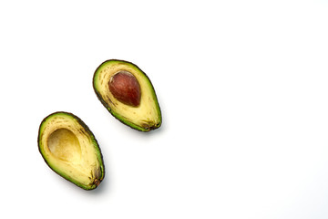 Two slices of avocado isolated on the white background. One slice with core. Design element for product label.