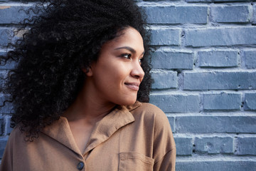  pretty young black woman with afro hair laughing and enjoying