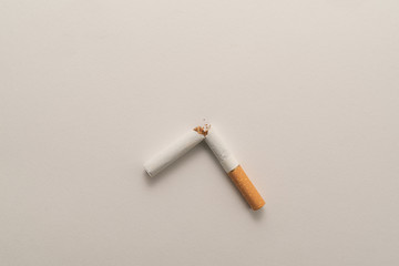 Broken cigarette on white background, World No Tobacco Day. Lung health concept.