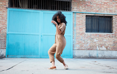  pretty young black woman with afro hair laughing and enjoying