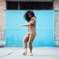  pretty young black woman with afro hair laughing and enjoying