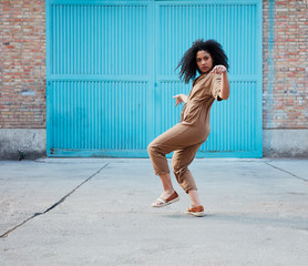  pretty young black woman with afro hair laughing and enjoying