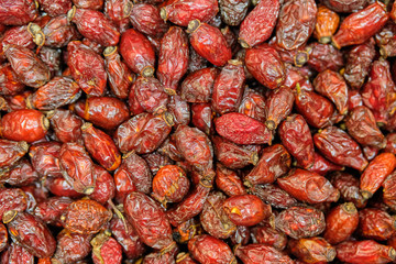 Background and texture of dry rose hips. Top view.