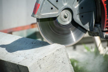 Fragment of a joint cutter on a brushed concrete surface.