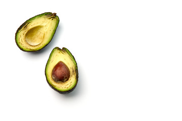A bad avocado cut in half on white background.