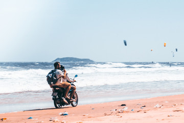 Fototapeta na wymiar Fantiet. Vietnam. 02/2020. Surfers on bike.