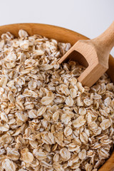 raw oat flakes on white acrylic background