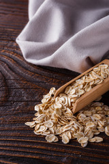 raw oatmeal on a wooden rustic background
