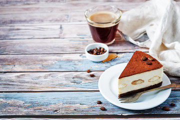 Tiramisu cake decorated with coffee beans with coffee drink
