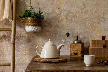 Stylish vintage kitchen interior with tea pot, cup of coffee, plant, wooden ladder and kitchen accessories. Minimalistic concept of kitchen space. Wabi sabi. Retro home decor. Template. 