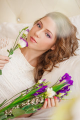 Obraz na płótnie Canvas Beautiful spring girl with flowers. Woman with beautiful make-up and hairstyle. Beautiful fashion model. Concept of allergies and allergens from flowering plants